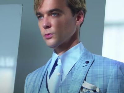 Jim Parsons is wearing a blue suit and a shirt in the picture.